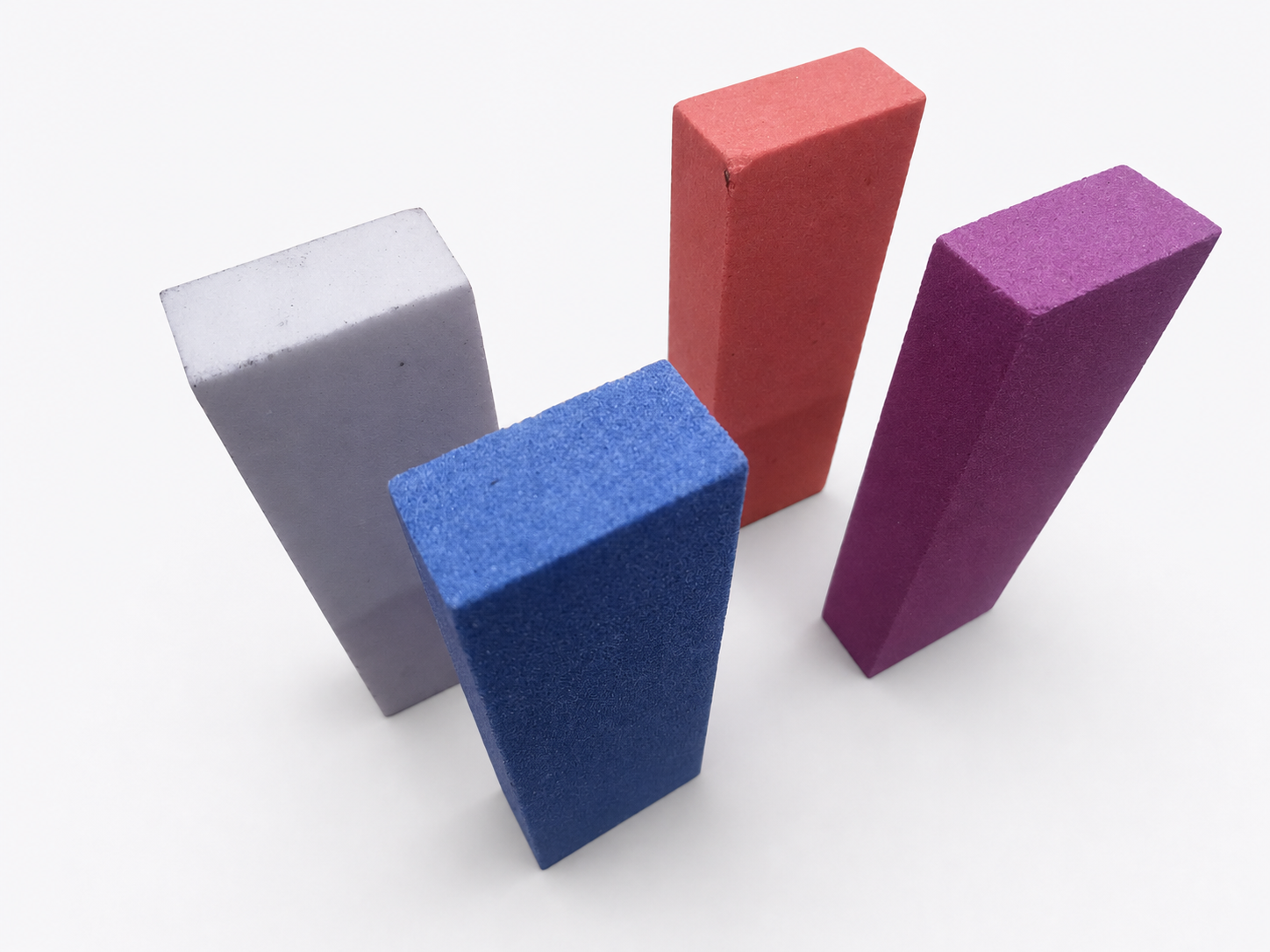 Clean studio image of coloured rectangular abrasive oil stones